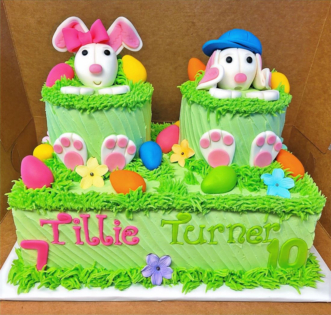 Easter cake decorated with bunnies and pastel eggs
