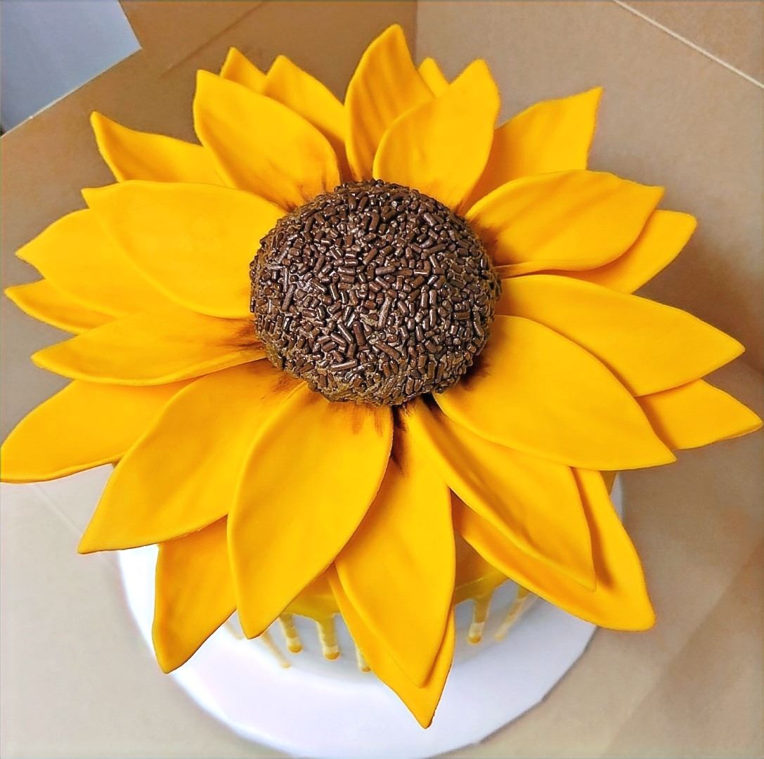 Sunflower cake iced in bright yellow petals