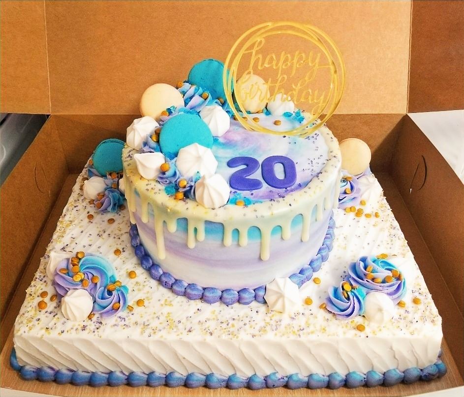 Twenty first birthday cake with a gold coin and blue drip