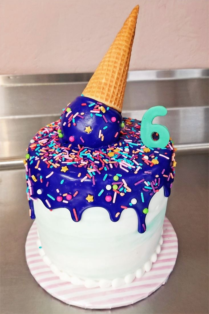 Ice cream cone drip cake in purple and white