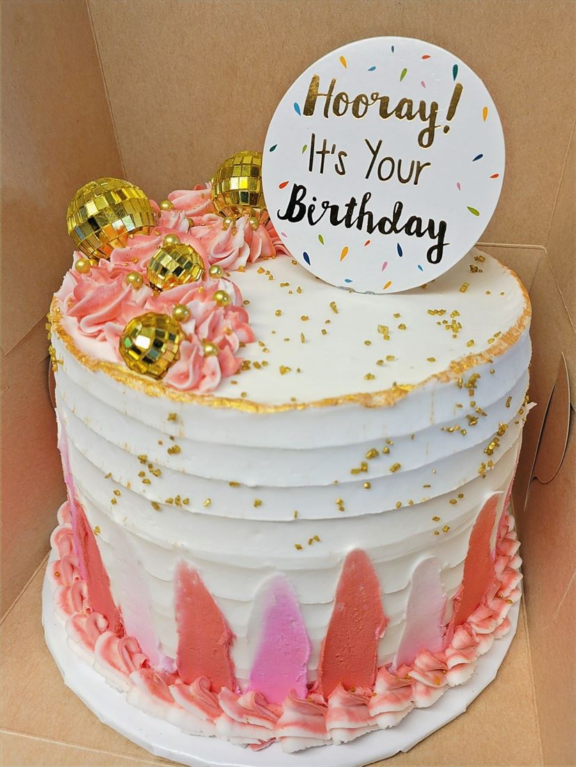 Pink and gold birthday cake with a hooray topper