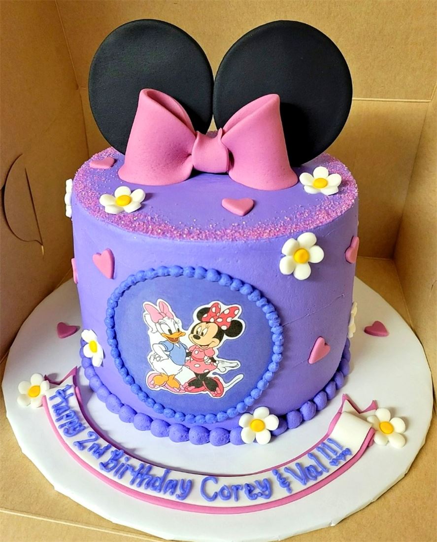 Minnie Mouse themed birthday cake in purple and pink