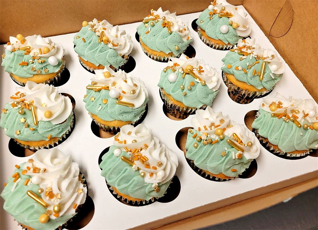Tray of cupcakes with pastel green frosting