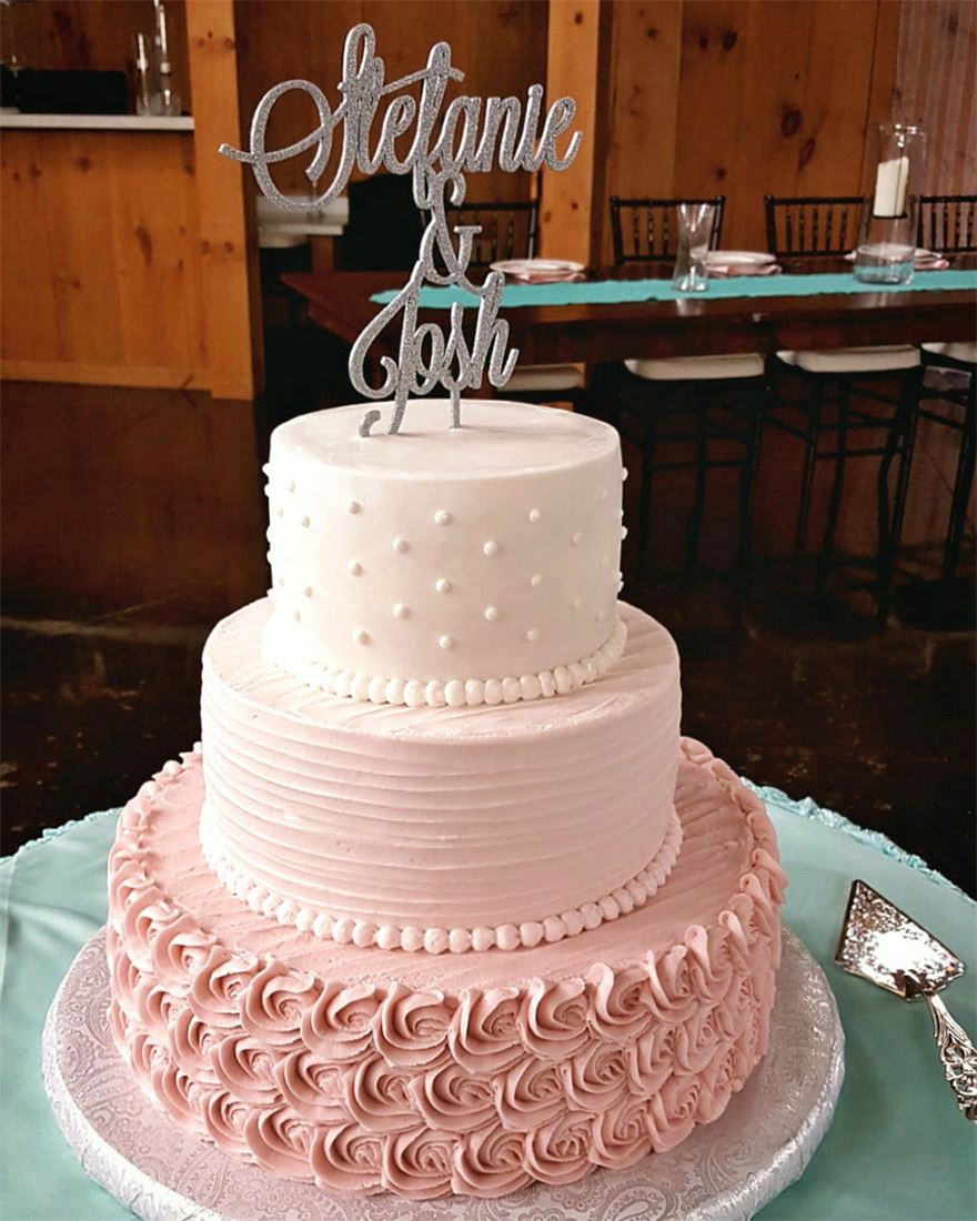 Blush pink wedding cake finished with rosette piping