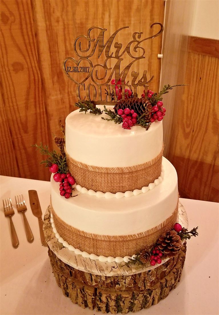 Semi-naked tiered cake decorated with sunflowers and burlap
