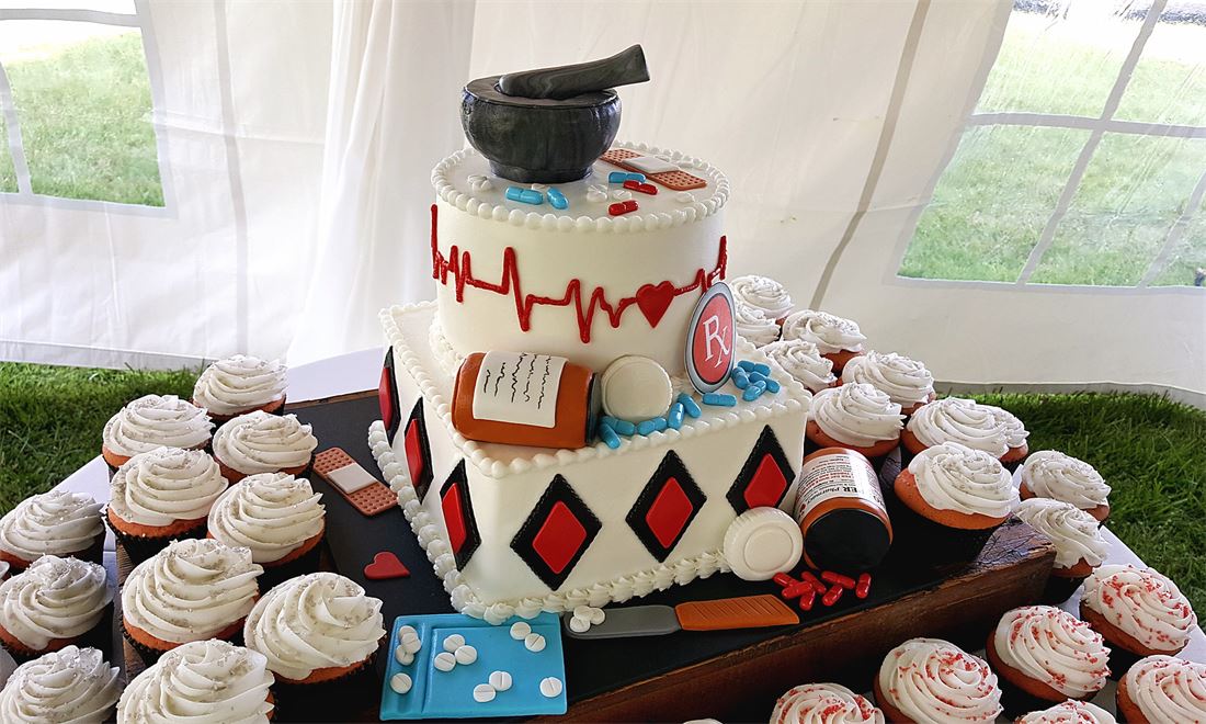 Card suit themed cake served with matching cupcakes